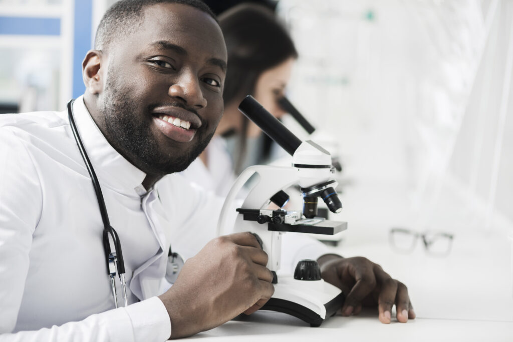 cheerful-ethnic-medic-microscope